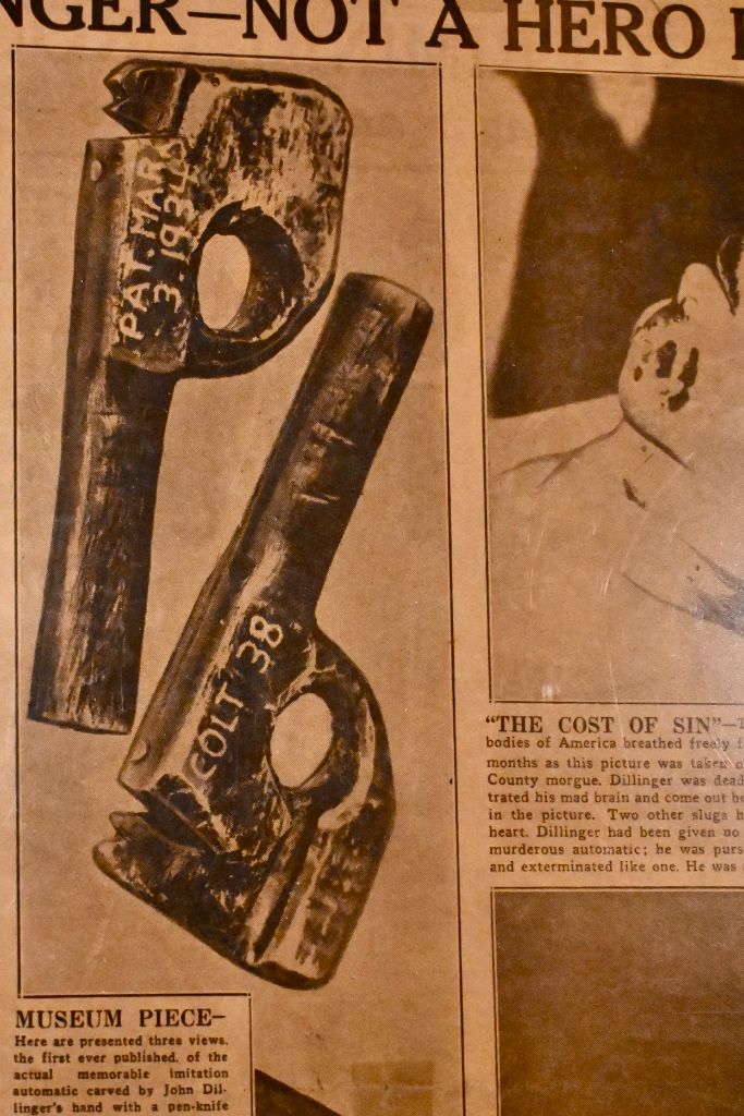 Close-up of the 1934 newspaper showing the wooden gun photographs and MUSEUM PIECE caption